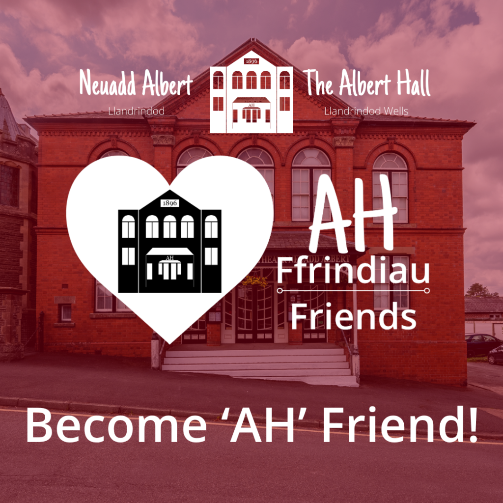 A promotional image for Albert Hall Friends showing the Albert Hall building in the background. At the top is the text “Neuadd Albert – The Albert Hall – Llandrindod Wells.” A white heart‑shaped logo on the left contains a simple line illustration of the hall with the words “AH Ffrindiau Friends.” Large text in the centre reads “Become ‘AH’ Friend!” over the building image.